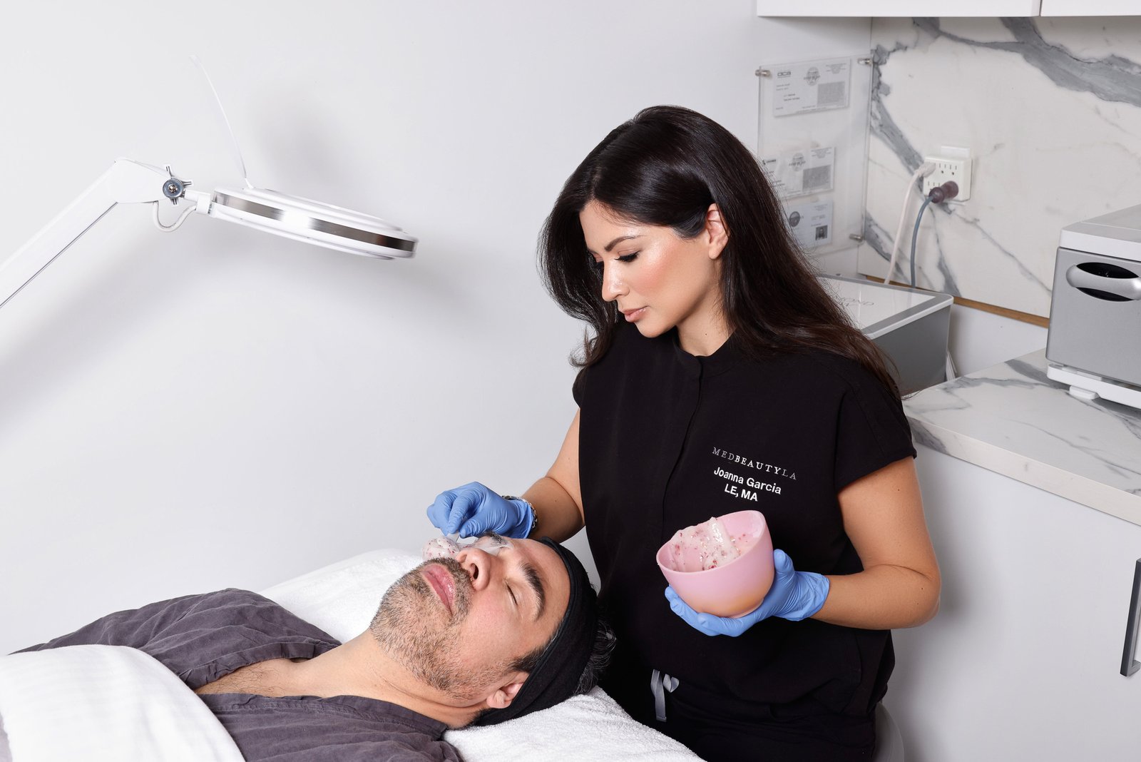 A MedBeautyLA aesthetician applying a mask during The Gentlemen's Facial