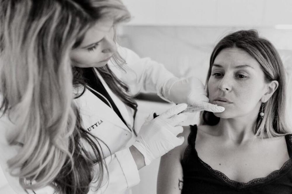 A MedBeautyLA injector carefully placing lip filler for a client in the Downtown LA office